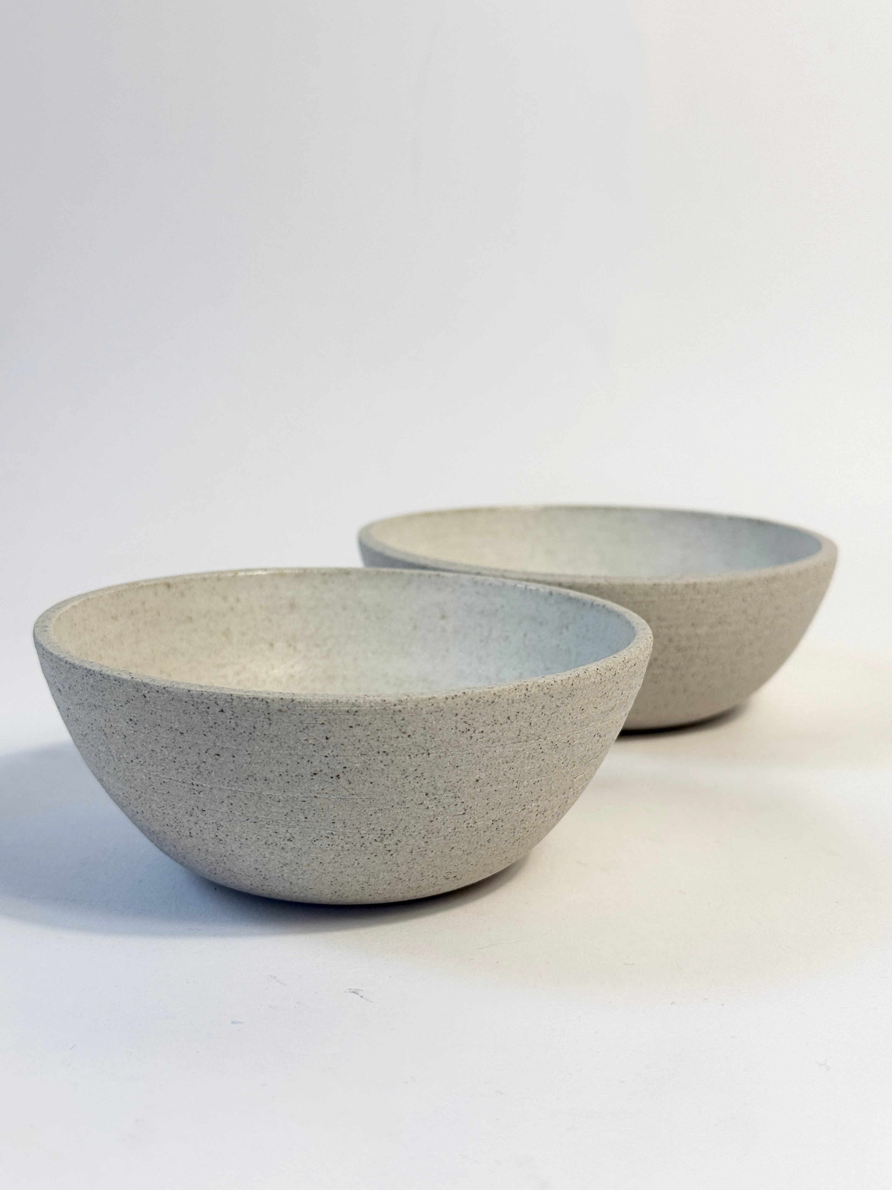 Two small speckled grey ceramic bowls with white glazed interior.  Created in Adelaide South Australia by FionaK