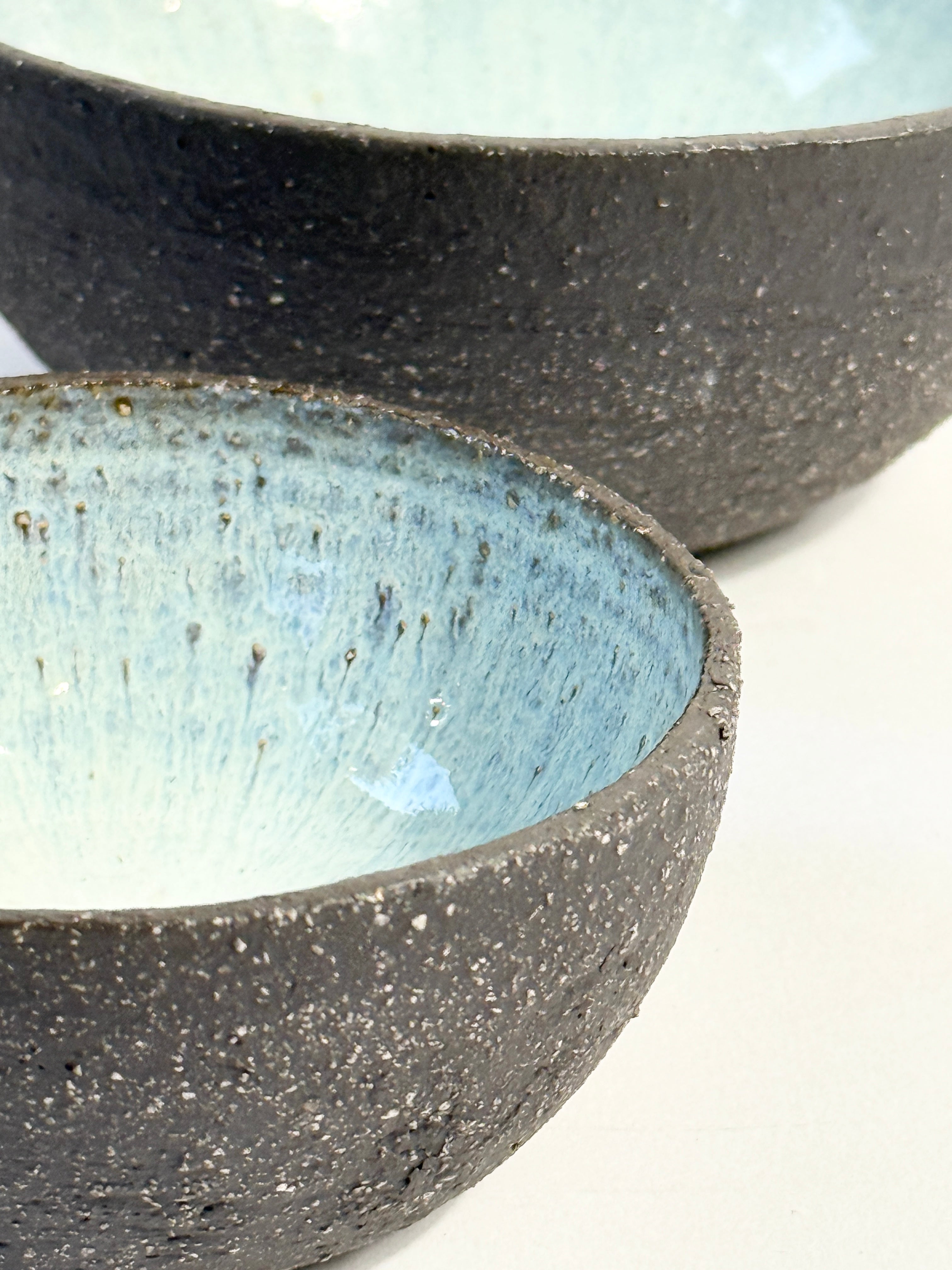 Beautiful glazed bowl set with pearl blue interior and unglazed exterior showing natural dark matter clay.  Unique and handcrafted in Adelaide by FionaK