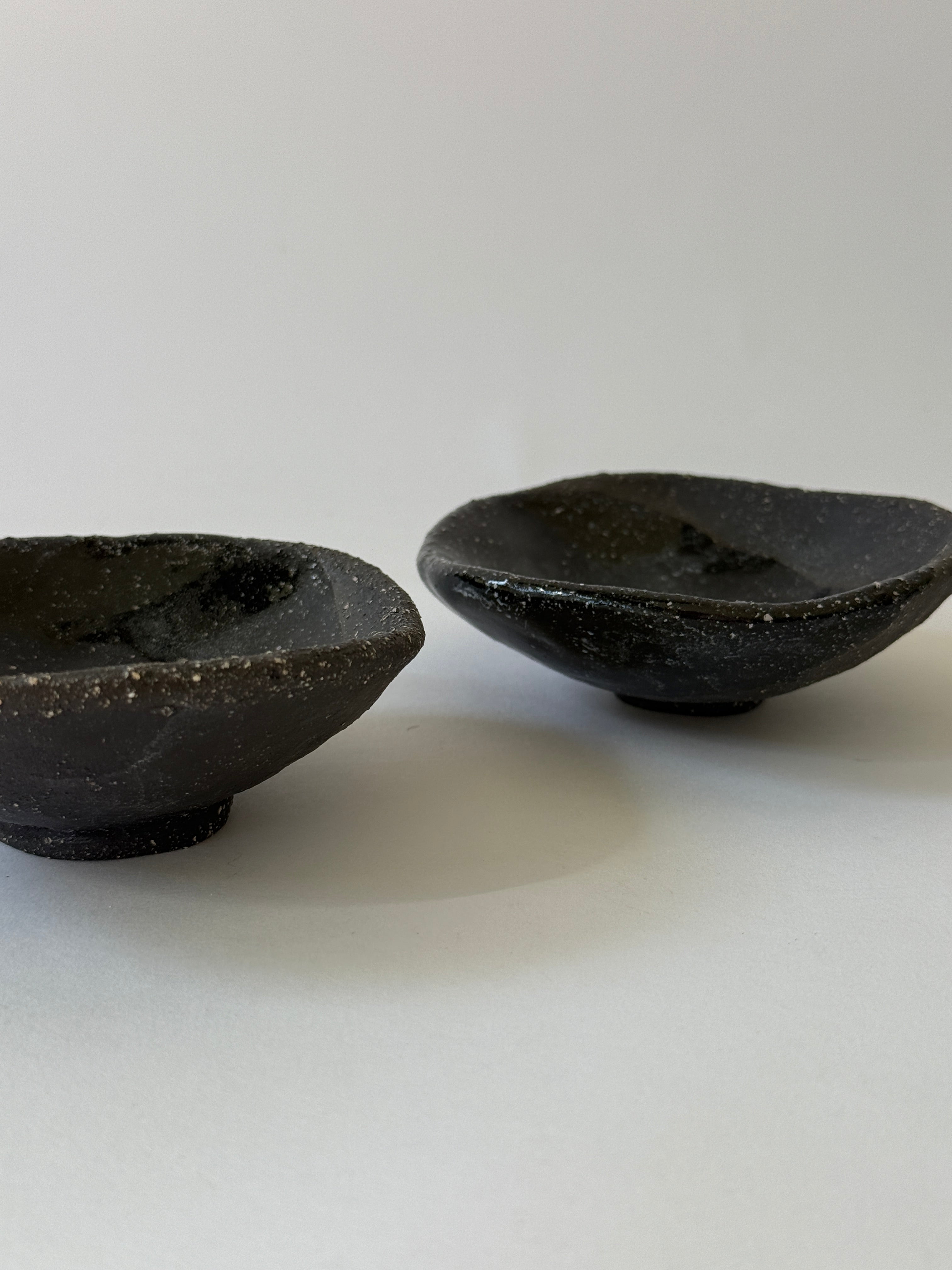 Unique hand built dishes with gritty black clay