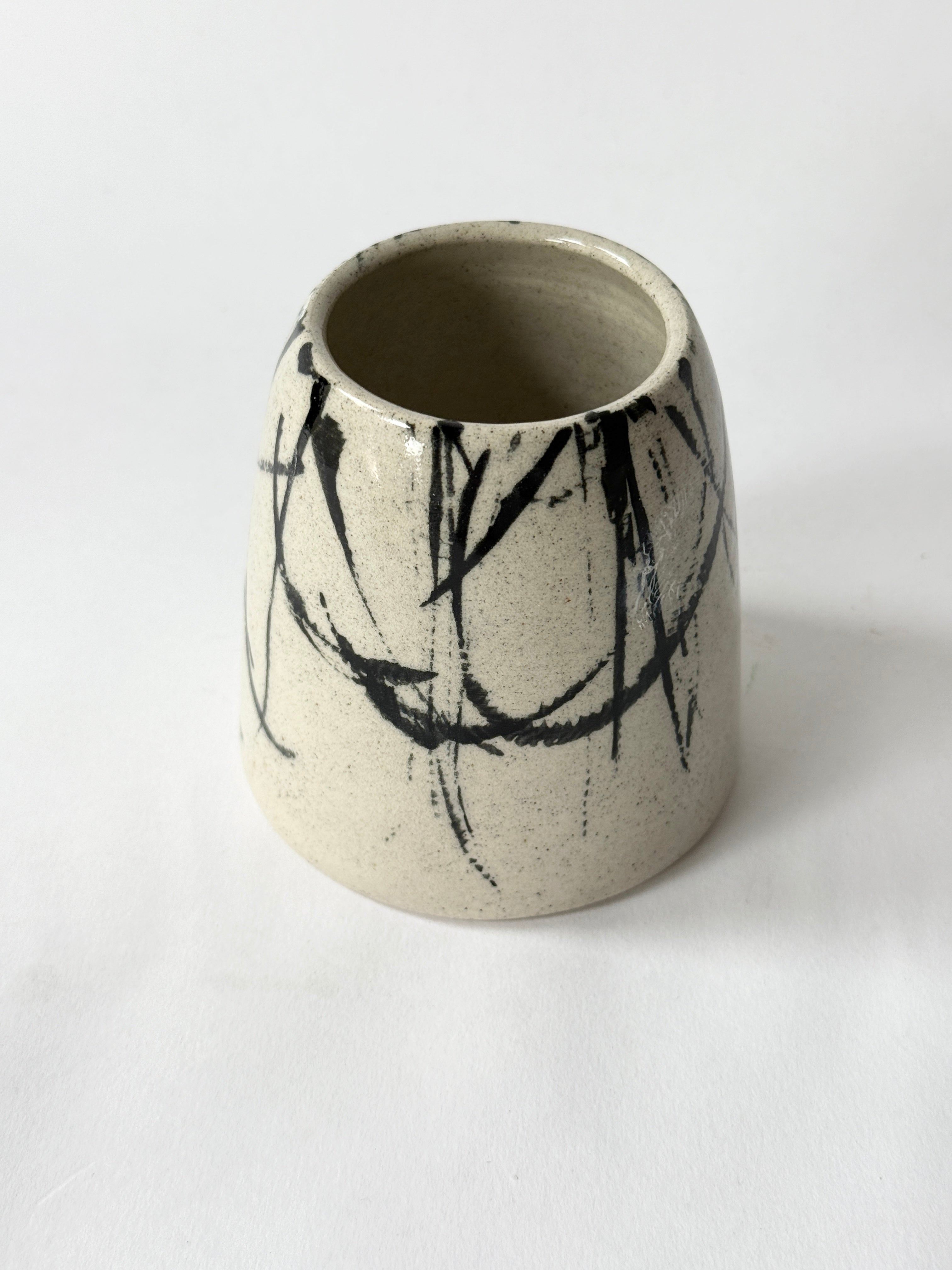 beautiful ceramic hand made vase with speckled clay and splatter design.  Desk vase