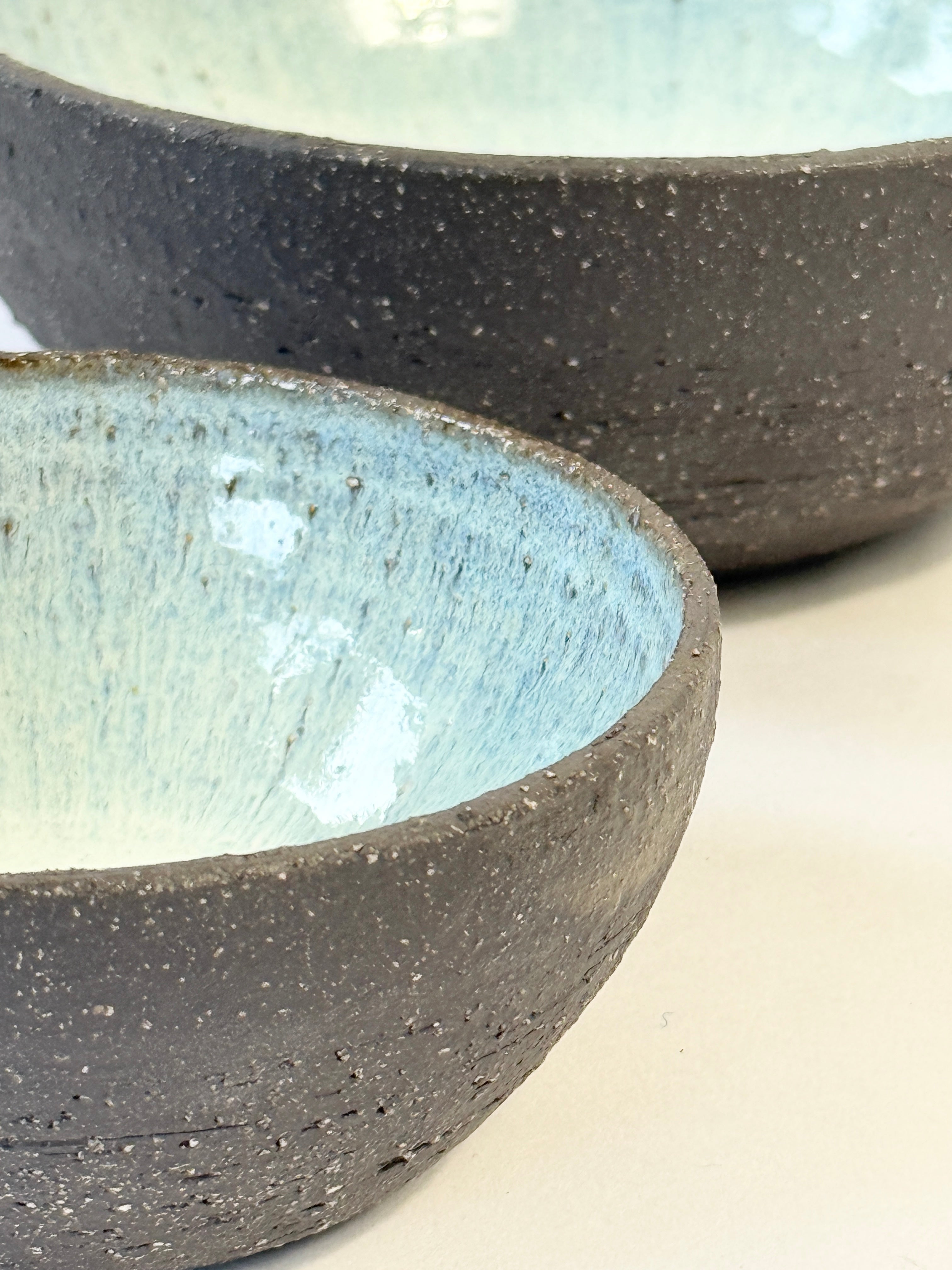 Beautiful pearl blue glazed interior bowl set with natural dark matter unglazed exterior.  Perfect for gifting. 