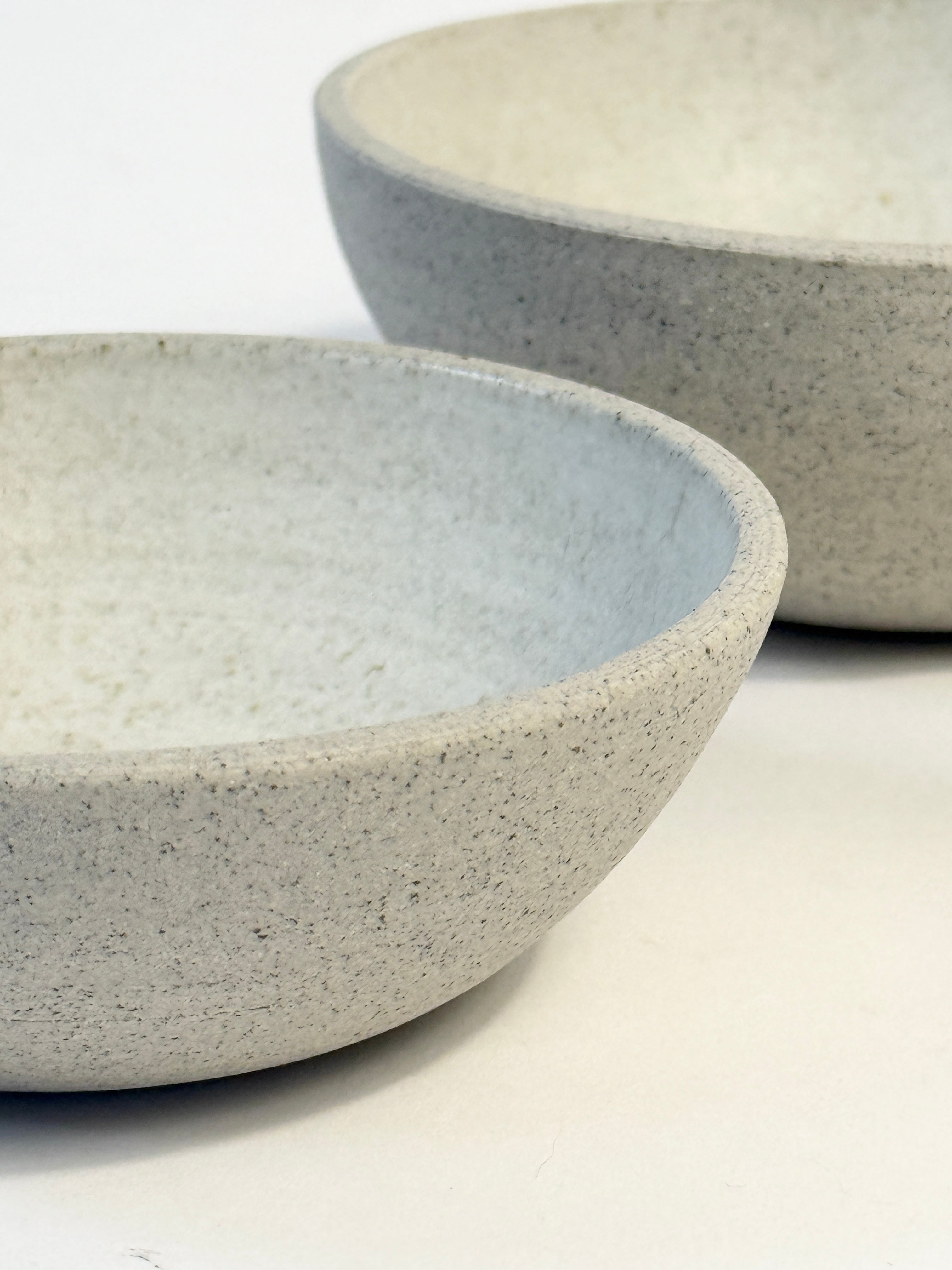 Two speckled ceramic bowls in a light gray and off-white tones.  Unique handmade bowl set.
